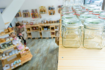 Closeup of empty glass jar in a zero waste shop.