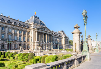 Three-quarter view of the colonnade and formal garden of the Royal Palace of Brussels, the official palace of the King and Queen of the Belgians in the historic center of Brussels, Belgium.