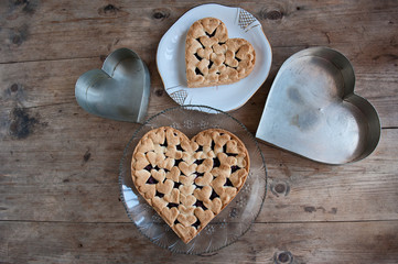 Cherry pie with heart shaped on the rustic background