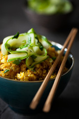 Traditional Burmese or Myanmar fried rice with shallots, turmeric and fresh cucumber strips mixed with chopped green onions and vinegar has been stir-fried in a wok and perfect for vegan. close-up