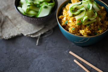 Traditional Burmese fried rice with shallots,turmeric and fresh cucumber strips mixed with chopped green onions and vinegar has been stir-fried in a wok and perfect for vegan. copy space,top view