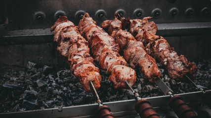 The meat is on charcoal close-up outdoors. Street food