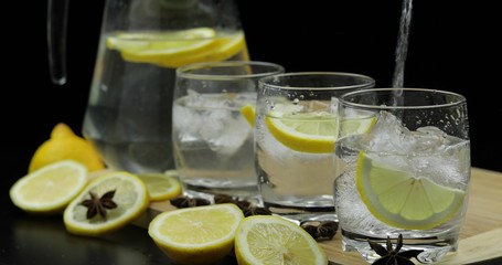 Pour lemon juice into glass with ice and lemon slices. Lemon alcoholic cocktail
