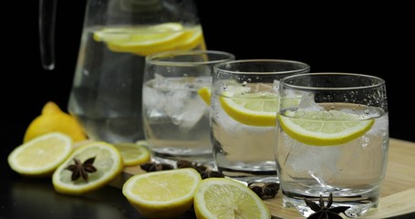 Lemon juice in glass with ice and lemon slices. Lemon cocktail