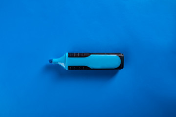 Office accessories. Blue highlighter on a blue background. 