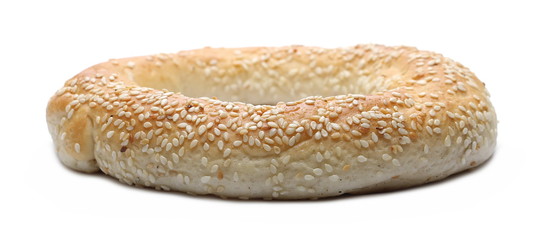 Bagel with sesame and wheat ears isolated on white background