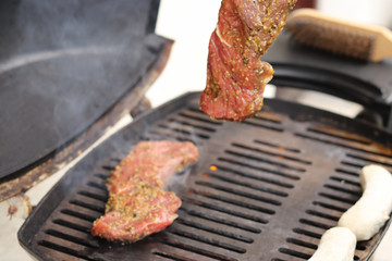 Side perspective on a grill with meat