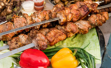 Grilled meat on the grill with fresh vegetables. Street food