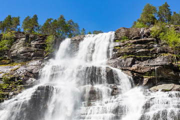 Fototapeta na wymiar Tvidefossen waterfall in spring. Voss, Norway.