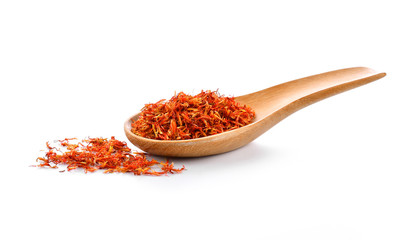 Safflower dried in wood spoon on white background