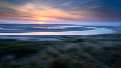 ICM Abstract of Budle Bay, the mud flats at low tide are part of Lindisfarne Nature reserve on...