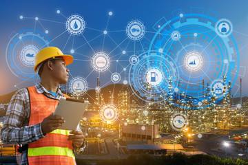 businessman hands hold tablet working with night oil refinery industry plant and industry icons....