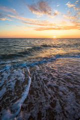 Fototapeta premium gorgeous sunset on the sea coast. photo on long exposure, waves at sea at sunset. pink sunset