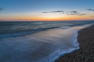 photo on long exposure, waves at sea at sunset