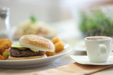 Beef hamburger with white cup of hot coffee in morning that most popular fast food.