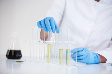 Scientist tearing the CBD oil from one tube into another