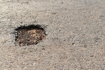 hole on asphalt road in countryside