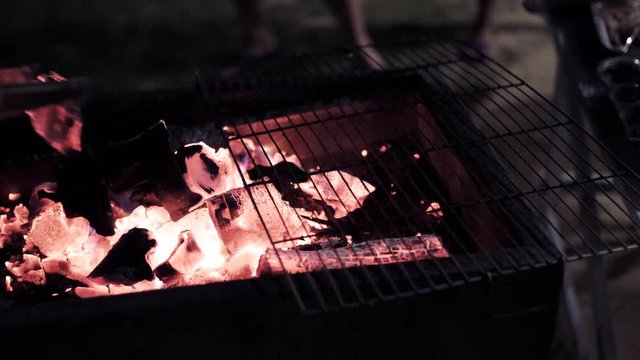 Glowing barbecue embers, fire charcoal in stove for cooking and grilling food or outdoors barbecue. Royalty high-quality free stock footage of embers burning with red and yellow flame 