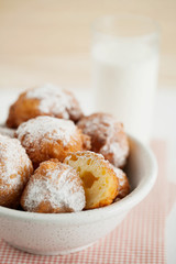Homemade deep-fried cottage cheese donuts for Breakfast on a light wooden background close-up. Fresh pastries for the morning. Selective focus