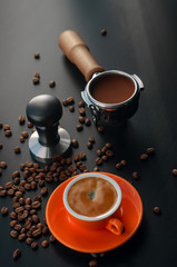 Tempera, holder, and orange barista cup with espresso. Equipment for making freshly brewed coffee