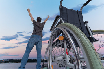 Disabled handicapped man is healthy again. He is happy and stand