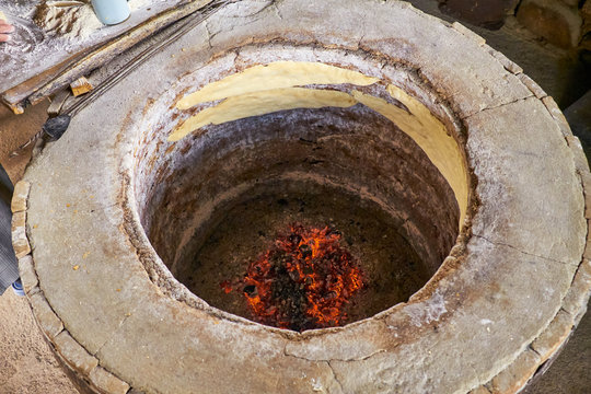 preparation of bread in a round stone oven