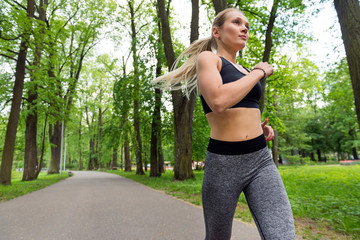 1 white slim athletic girl running in the Park among the trees, runner,