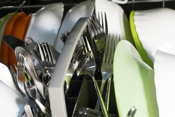 clean plates and cutlery in the dishwasher