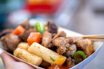 Pan-fried black pork meal in Korea traditional market, delicious korean food cuisine with carrot and shallot green onion, close up, copy space