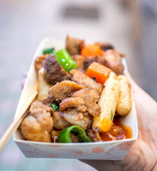 Pan-fried black pork meal in Korea traditional market, delicious korean food cuisine with carrot and shallot green onion, close up, copy space