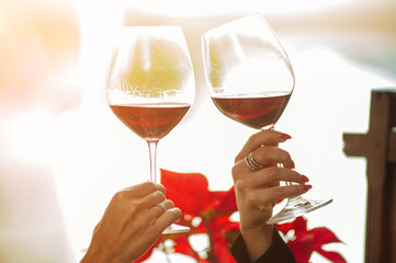 Holyday and rest. Female friends celebrating with wine in a bar and toasting with glasses of wine.
