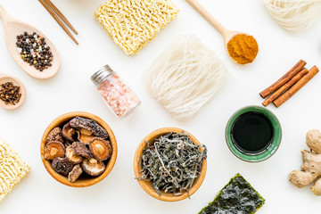 Chinese and Japanese food cooking with ginger, spices and noodles on white background top view geometric pattern