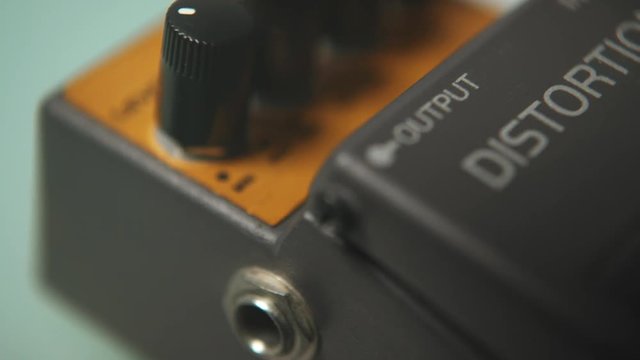 Close up shot of a guitar distortion effect pedal. Shallow depth of view
