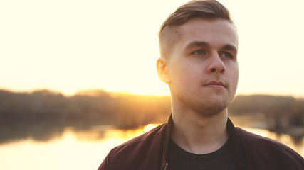 Young thoughtful handsome man enjoying sunlight