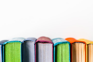 Old books standing in a row on white background