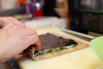 cooking and preparing japanese roll maki