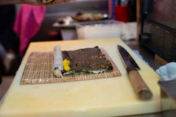 cooking and preparing japanese roll maki