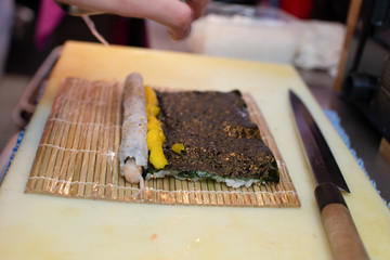 cooking and preparing japanese roll maki