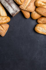 Vertical border with bread on dark table