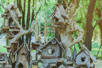 Hand made wooden bird house nest  in public Park , hand wood shelter for birds .