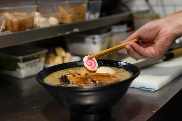 preparing and cooking japanese ramen with meat and vegetables