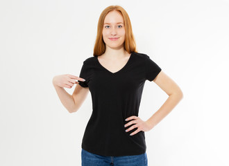 Fototapeta premium t-shirt design, happy people concept - smiling red hair woman in blank black t-shirt pointing her fingers at herself, red head girl tshirt mock up