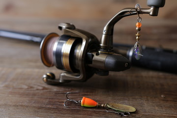 spinning with reel and lure on wooden background