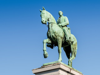 Low angle view of the equestrian statue of King Albert I of Belgium on the Mont des Arts in Brussels, Belgium, against blue sky.