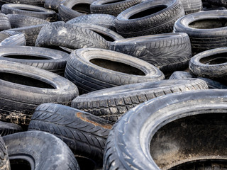 Large pile of tires dump. Illegal garbage dump. The concept of ecology pollution.