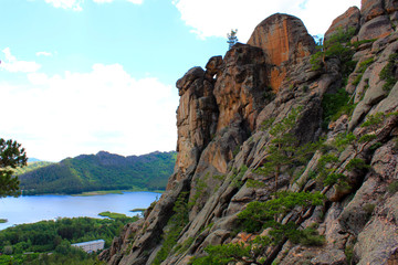 rocky mountain and lake in the background