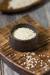 Sesame in a wooden bowl on a wooden Board. Rustic style