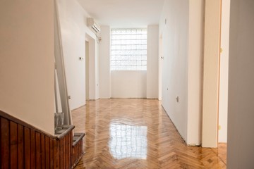 white house hallway with parquet floor and window