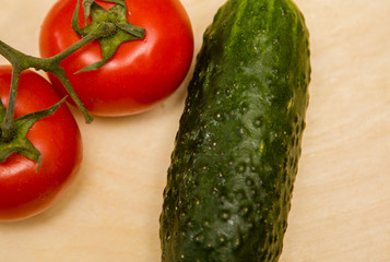 ripe vegetables cucumbers and tomatoes on an open background