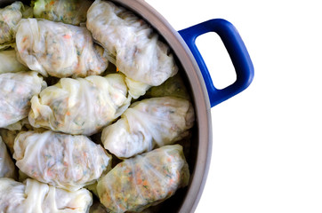 Cabbage Rolls or Dolma. Stuffed cabbage leaves with minced meat, rice, vegetables and herbs in casserole. Isolated on white backround with copy space for your text. Top view. Sarma, golubtsy, golabki